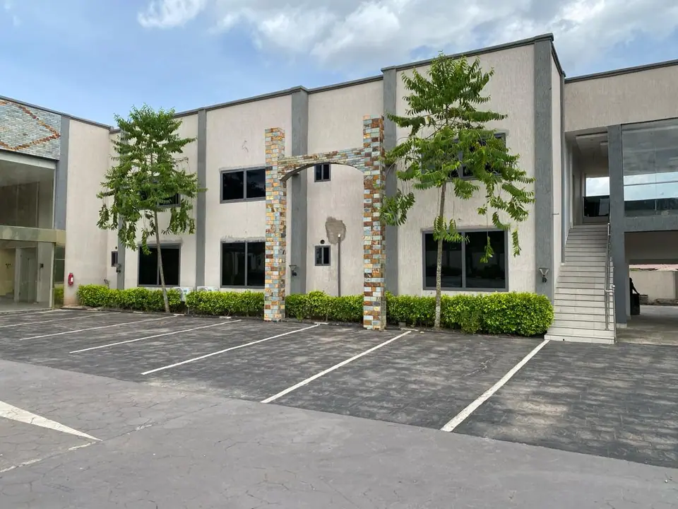 Guest wing exterior with stone pillars and trimmed hedges
