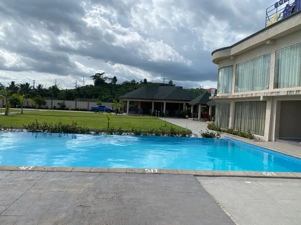 The outdoor swimming pool and lawns