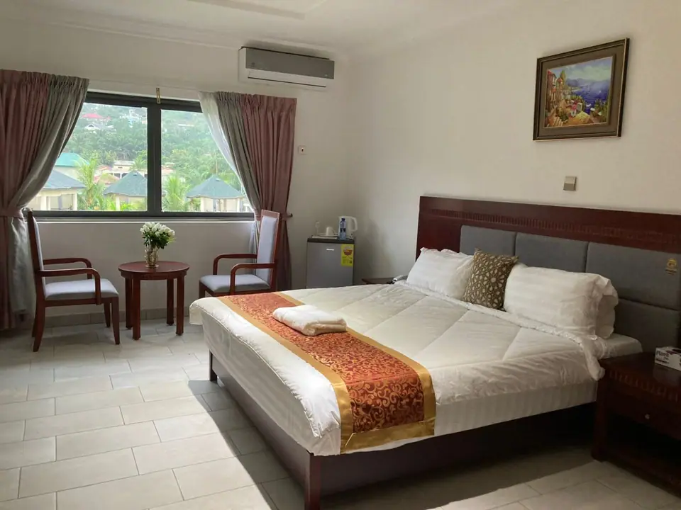 Deluxe First Floor room with king bed and seating by the window