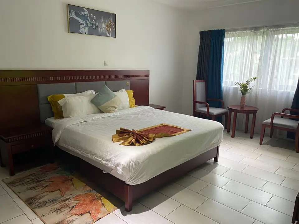 Deluxe First Floor room with king bed and armchairs