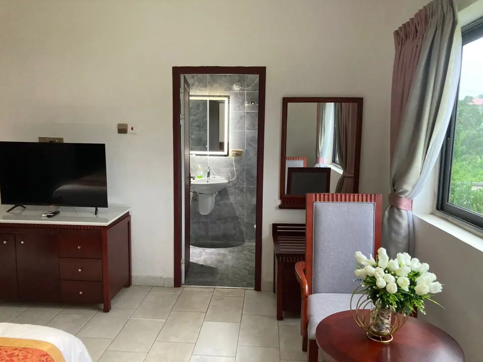 Deluxe room with fresh flowers on the side table
